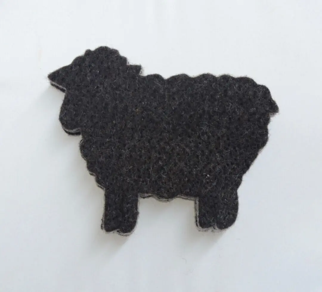 A black sheep-shaped knitted piece.