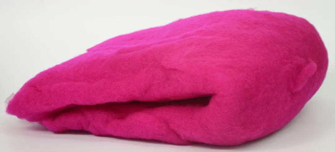 Close-up of a soft, bright pink fabric with a visible seam.